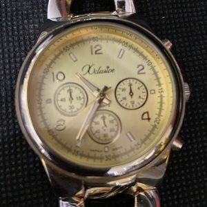 Vintage Xclusive Silver bracelet band with gold face tone- used